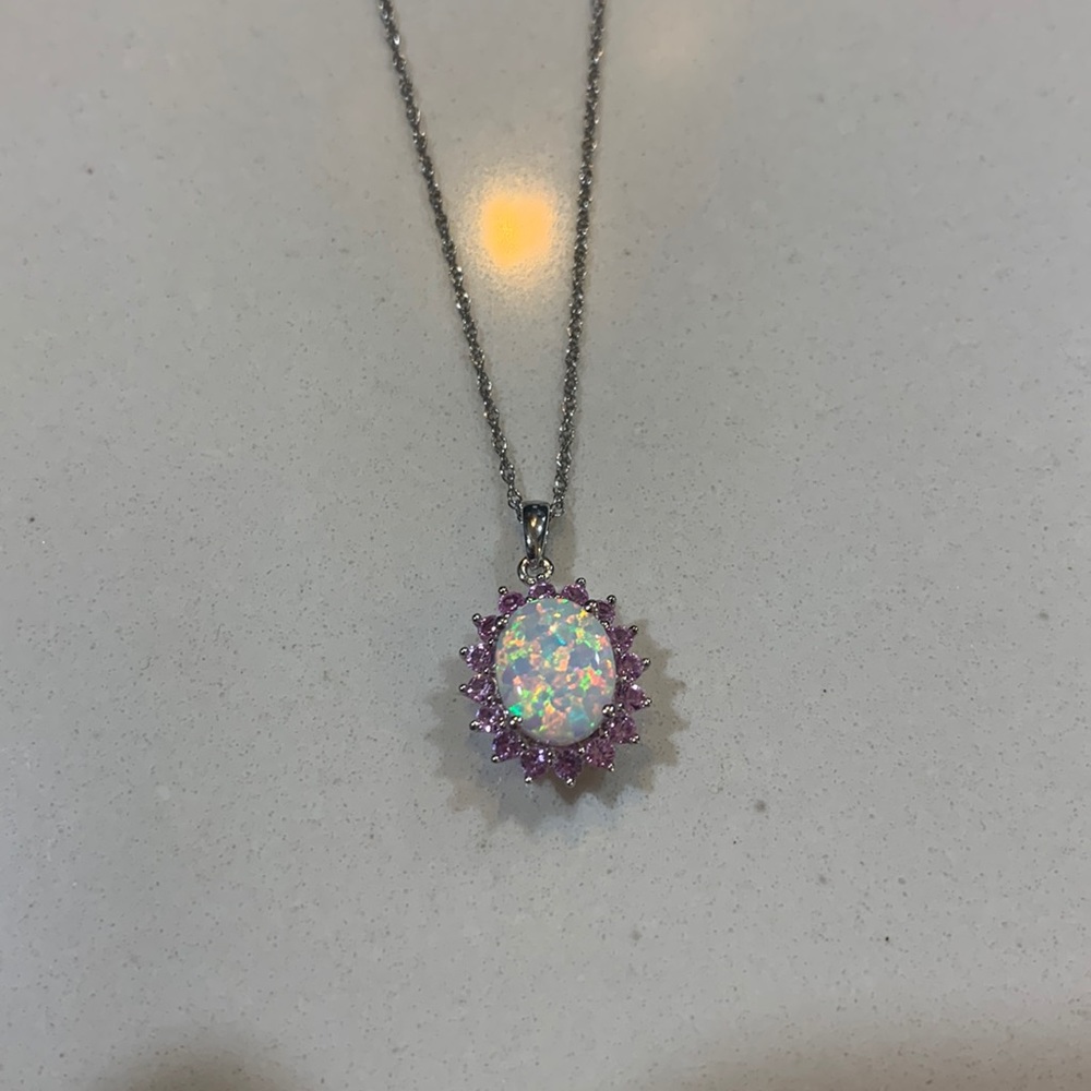 So pretty opal pendant surrounded by pink sapphires.